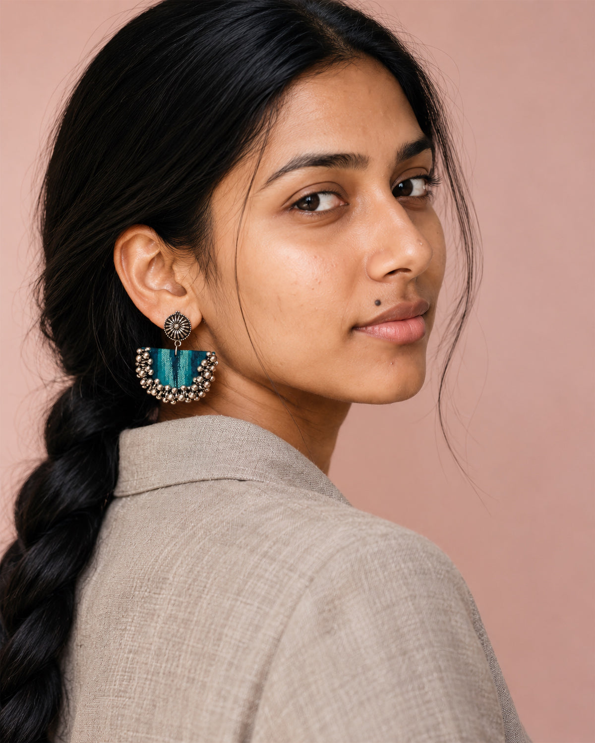 Teal Green Chandbali Earrings with Ghungroo worn with a long braid and a linen jacket against a blush wall: teal striped fabric crescent, kundan stud and silver ghungroo bells