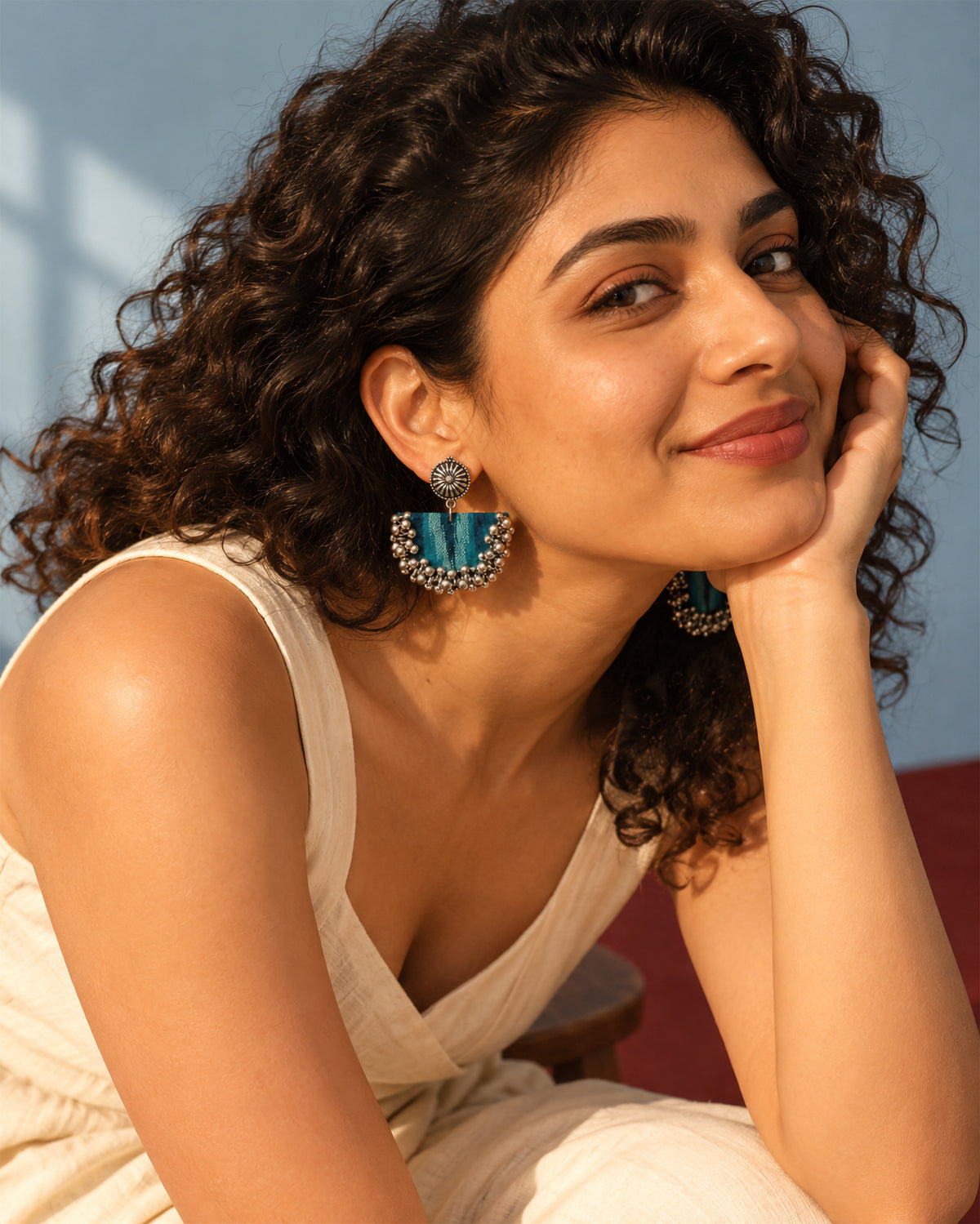Teal Green Chandbali Earrings with Ghungroo, worn, hand at the cheek, white top, pale blue wall