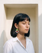 Teal Green Geometric Ghungroo Earrings worn with a white cotton shirt in an ivory lime-plaster niche (AI-generated styling image)