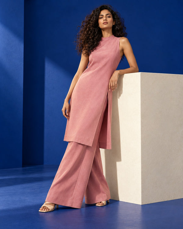Gulshan Halter Neck Ethnic Co-ord Set worn by a model leaning on a plinth against cobalt walls (AI-generated styling image)