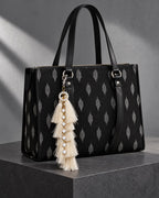 Motiya silk tassel charm clipped to the Noor Black Ikat Laptop Tote Bag