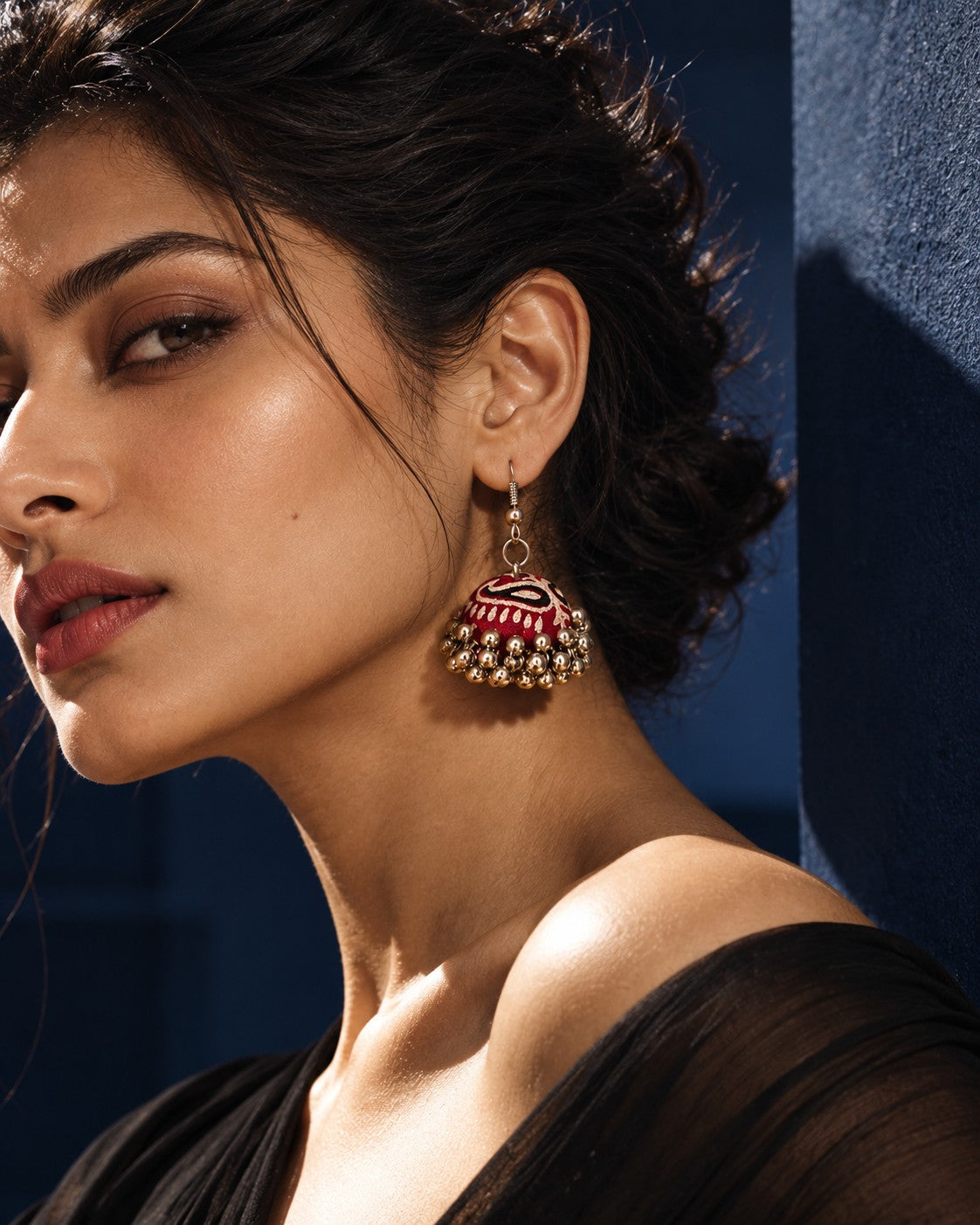 Marigold Zigzag Jhumka Earrings worn on a model against a blue-grey ground (AI-generated styling image)
