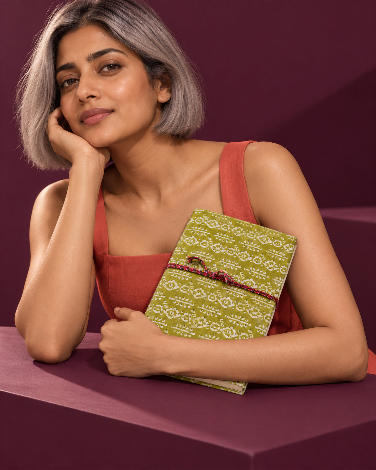 Mehendi Buti Block Print Fabric Diary, 200 Unruled Pages, held at the chest, coral dress, pink wall