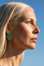 Mogra Firozi Pentagon Kundan Stud in profile against a blue sky: a turquoise blue five-sided fabric centre with three kundan stones and a border of small kundan