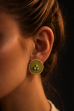 Close-up of the Mogra lime green kundan stud on the ear in warm light: round lime green fabric centre, three kundan stones and a small kundan border