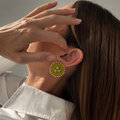 Mogra Lime Green Round Kundan Studs worn on the ear as she tucks her hair back: a lime green fabric centre with three kundan stones and a border of small kundan