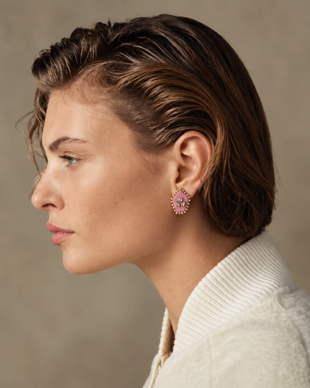 Mogra Pink Pentagon Kundan Studs in profile with slicked-back hair and an ivory jacket: three kundan stones on pink fabric, edged with small kundan
