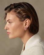 Mogra Pink Pentagon Kundan Studs in profile with slicked-back hair and an ivory jacket: three kundan stones on pink fabric, edged with small kundan