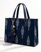 Nisha silk tassel charm clipped to the Midnight Ikat Laptop Tote Bag, Navy