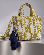 Nisha silk tassel charm clipped to the Matsya Mini Quilted Cotton Tote