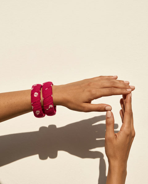 Gulnaar magenta pink printed fabric bangles worn on the wrist
