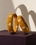 Pair of Haldi Phool mustard yellow fabric bangles showing the hand-wrapped printed cotton