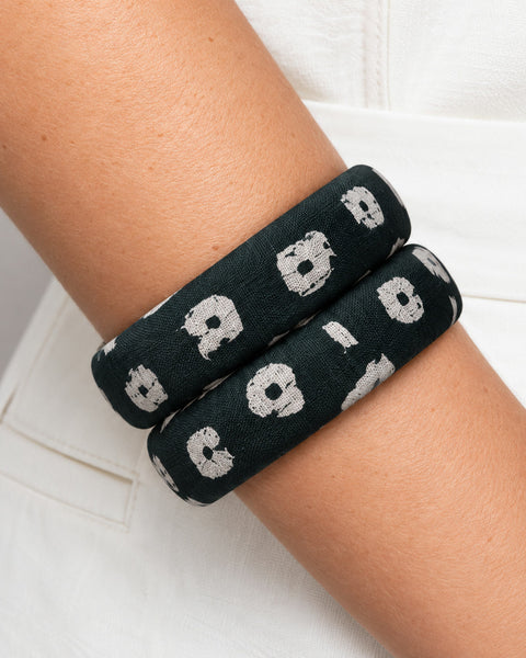 Close-up of the screen-printed floral cotton on Panna Phool dark green bangles worn on the wrist