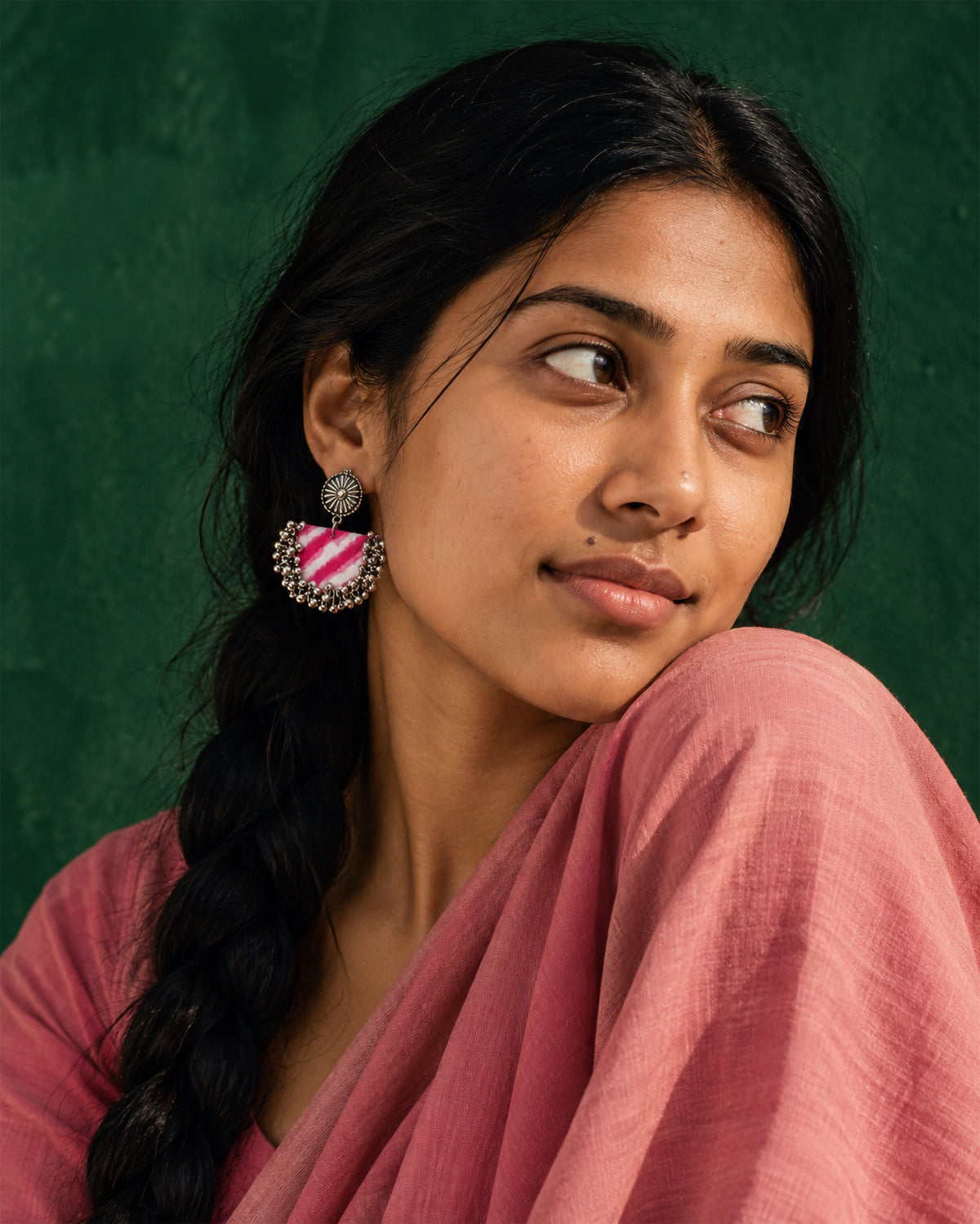 Rani Pink Chandbali Earrings with Ghungroo, worn, braid over the shoulder, pink top, deep emerald wall