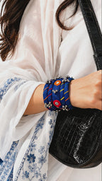 Rangriti blue fabric kada and four bangles with mirror work and ghungroo bells as the wrist moves slowly (AI-generated styling video)