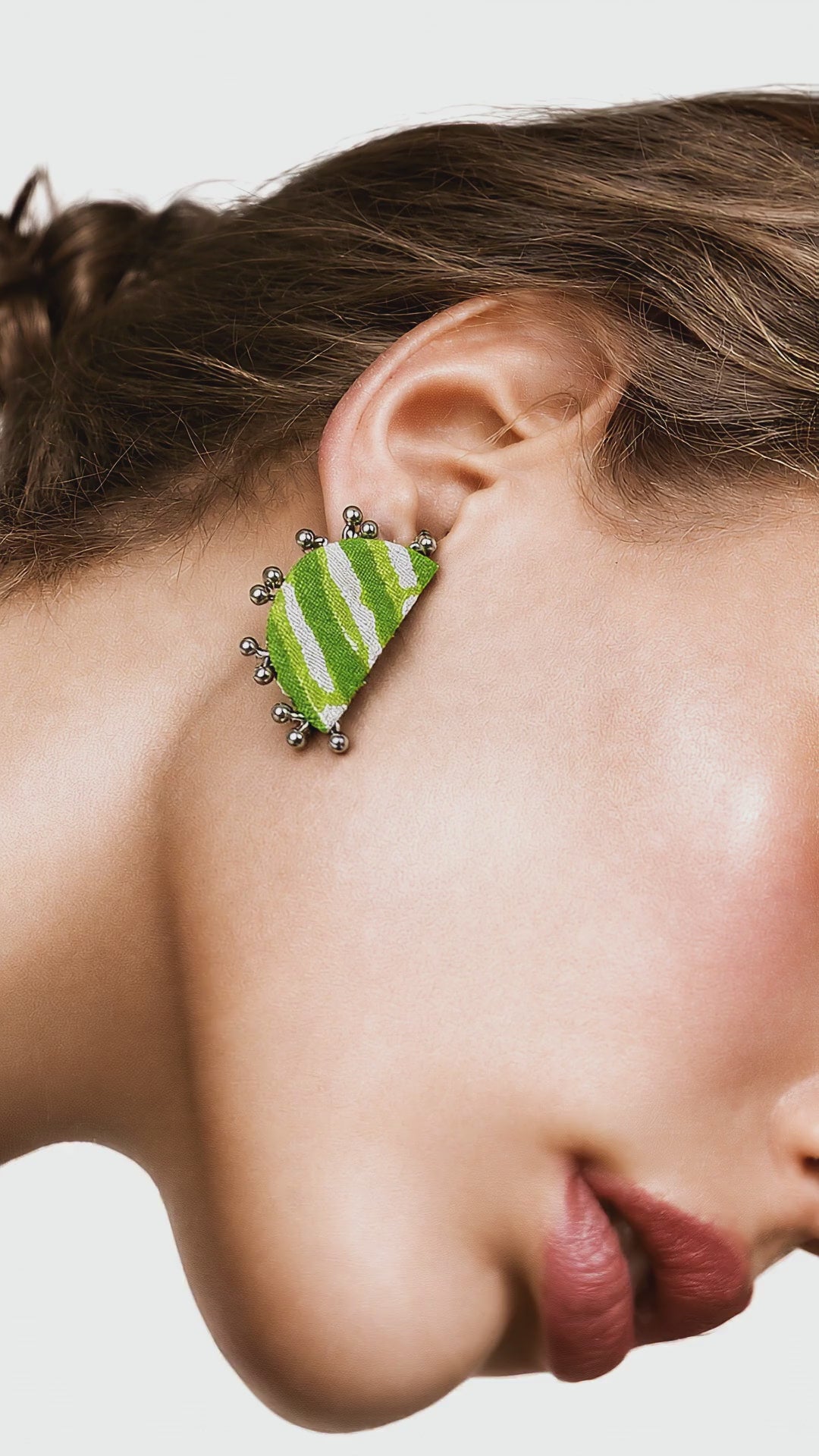 Leher Lime Green half moon stud with lime and white lehariya stripes and silver-tone beads, worn in profile (AI-generated styling video)