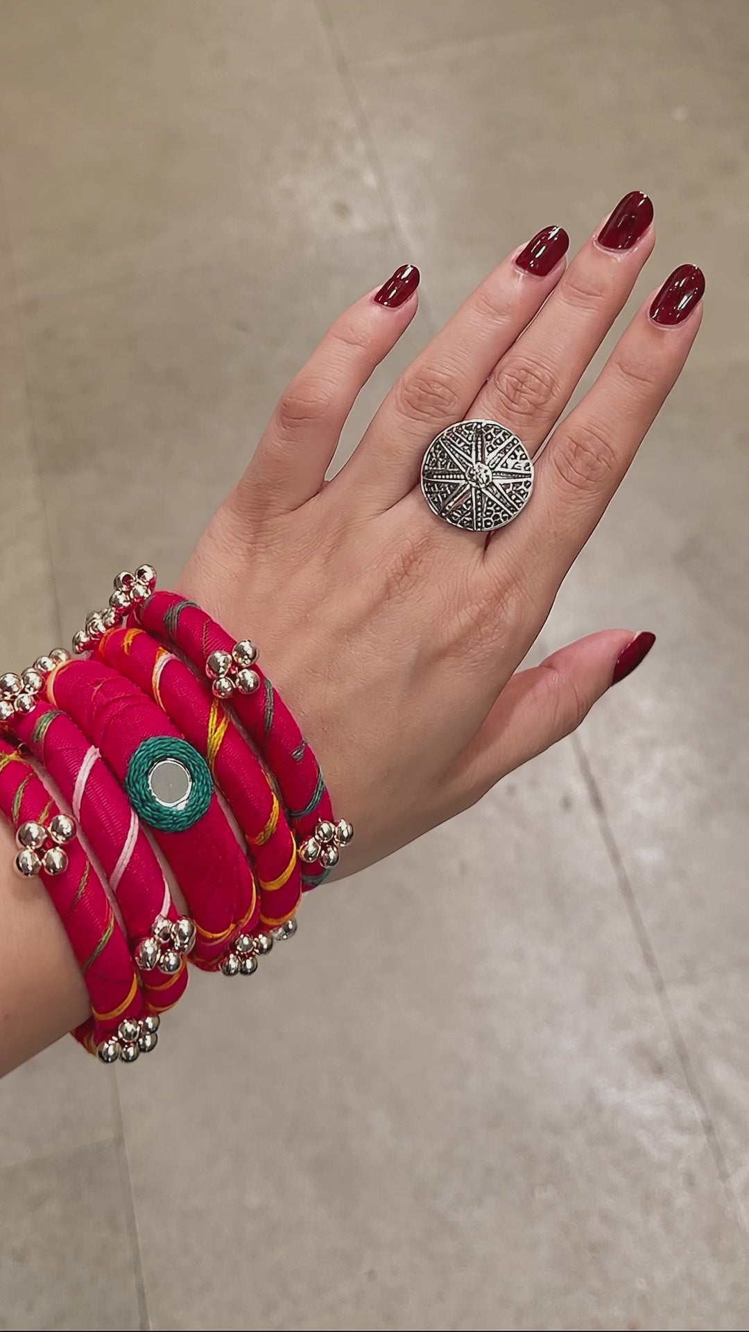 Rangriti pink fabric kada and four bangles with mirror work and ghungroo bells as the wrist turns slowly (AI-generated styling video)