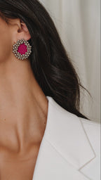 Fuchsia Pink Ghungroo Stud Earrings with two rows of tiny silver bells, worn with a white blazer, the light glinting on the bells (AI-generated styling video)