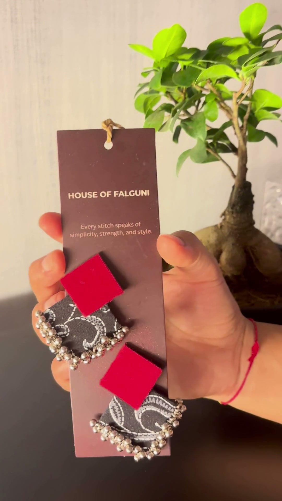 Black & Maroon Geometric Ghungroo Earrings: Black and Maroon Geometric Ghungroo earrings on a House of Falguni card, brought up close: deep red square stud over a black paisley-print fabric diamond edged with ghungroo bells