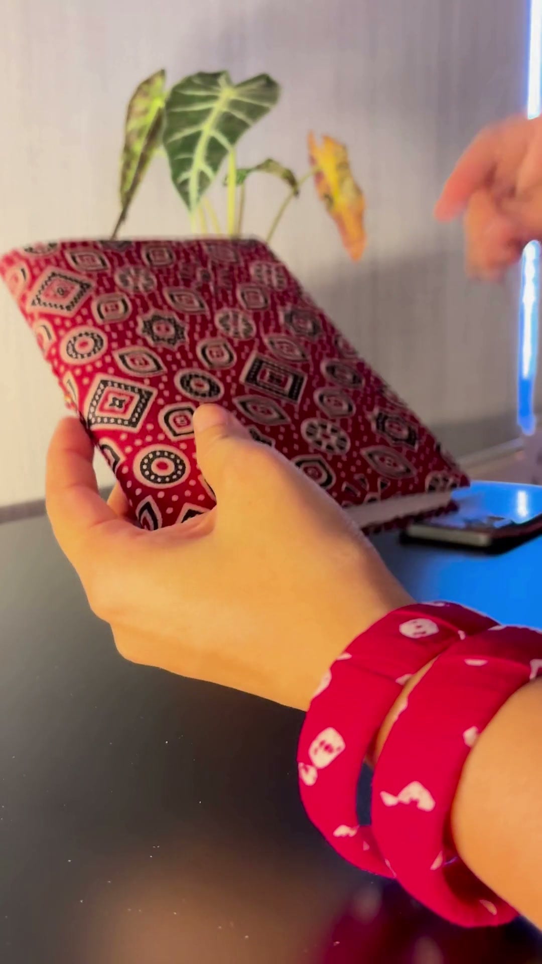 Crimson Ajrakh Block Print Fabric Diary, 200 Unruled Pages: Crimson Ajrakh block print fabric diary: picked up, the braided cord unwound, opened to unruled pages, then tied shut again