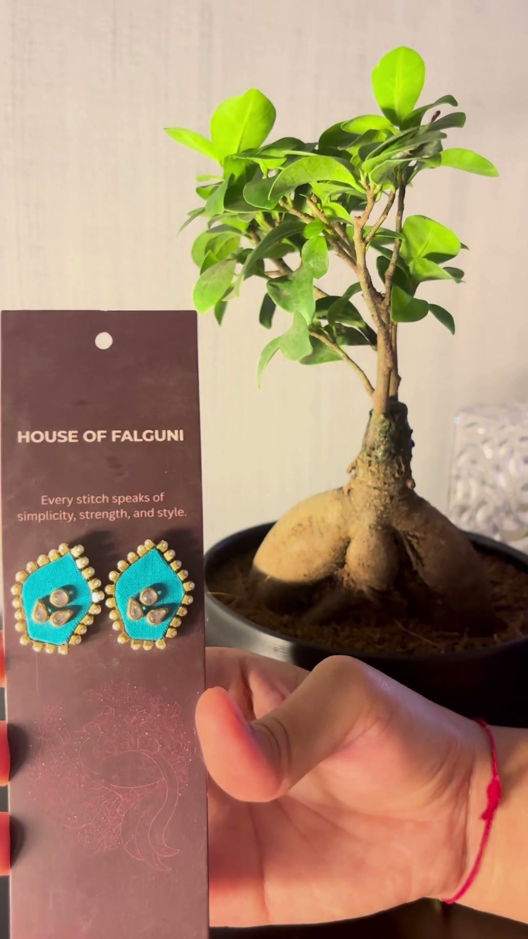 Mogra Firozi Pentagon Kundan Studs: Mogra Firozi Pentagon Kundan Studs on a House of Falguni card, tilted in the light: firozi pentagon fabric studs with three kundan stones and a small kundan border