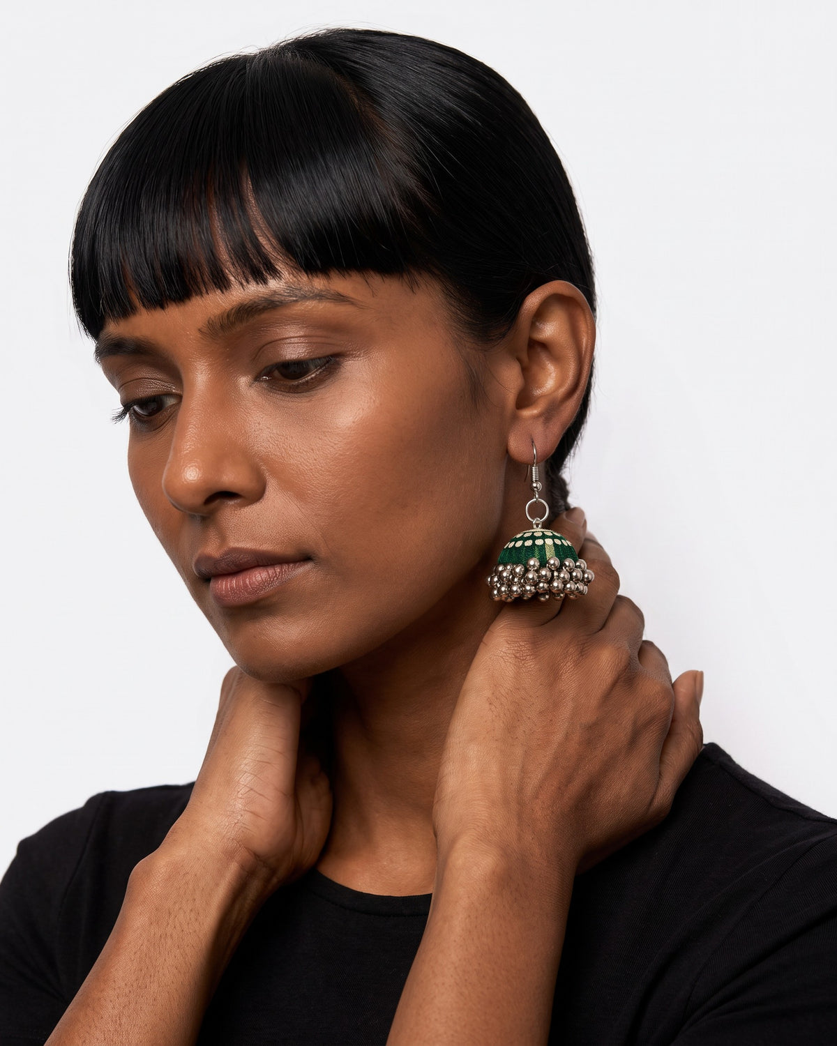 Rangrez Stripe Jhumka Earrings worn on a model in a black tee, grey studio (AI-generated styling image)