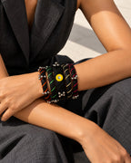 Rangriti black fabric kada and four bangles with mirror work and ghungroo, worn by model with crossed forearms (AI-generated styling image)