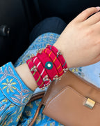 Rangriti pink ghungroo bangles worn with a blue printed kurta and a tan handbag