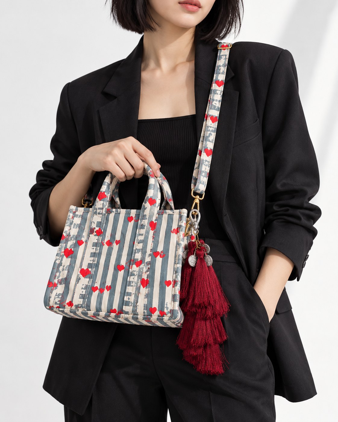 Raktima silk tassel charm clipped to the Jal Mini Quilted Cotton Tote