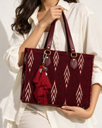 Raktima silk tassel charm clipped to the Ruby Ikat Red Laptop Tote Bag