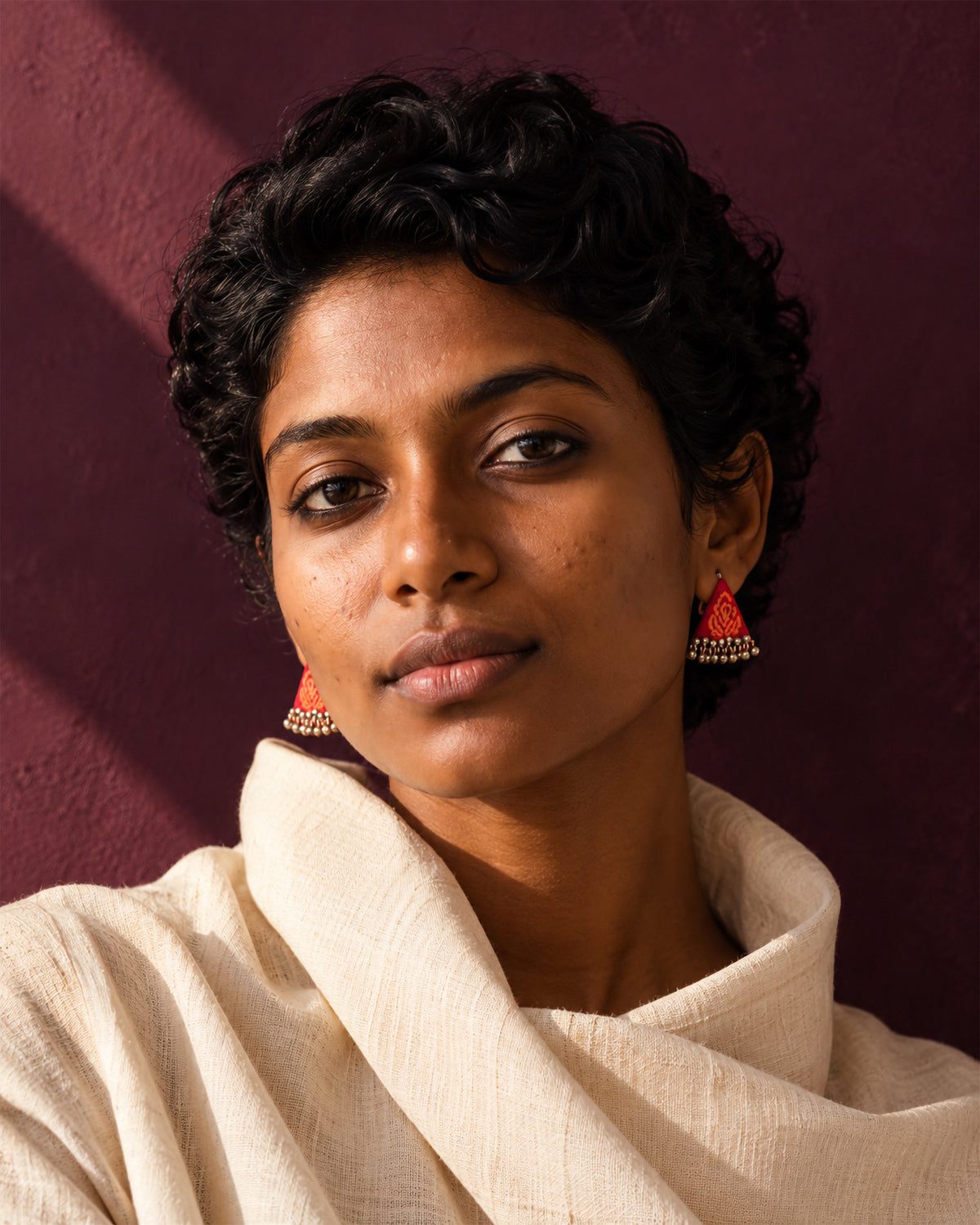 Riwaayat Gulnaar Red Triangle Earrings, worn, cream drape, aubergine wall