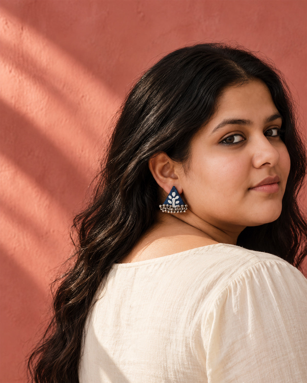 Riwaayat Ambar Indigo Triangle Earrings, worn, cream top, terracotta pink wall