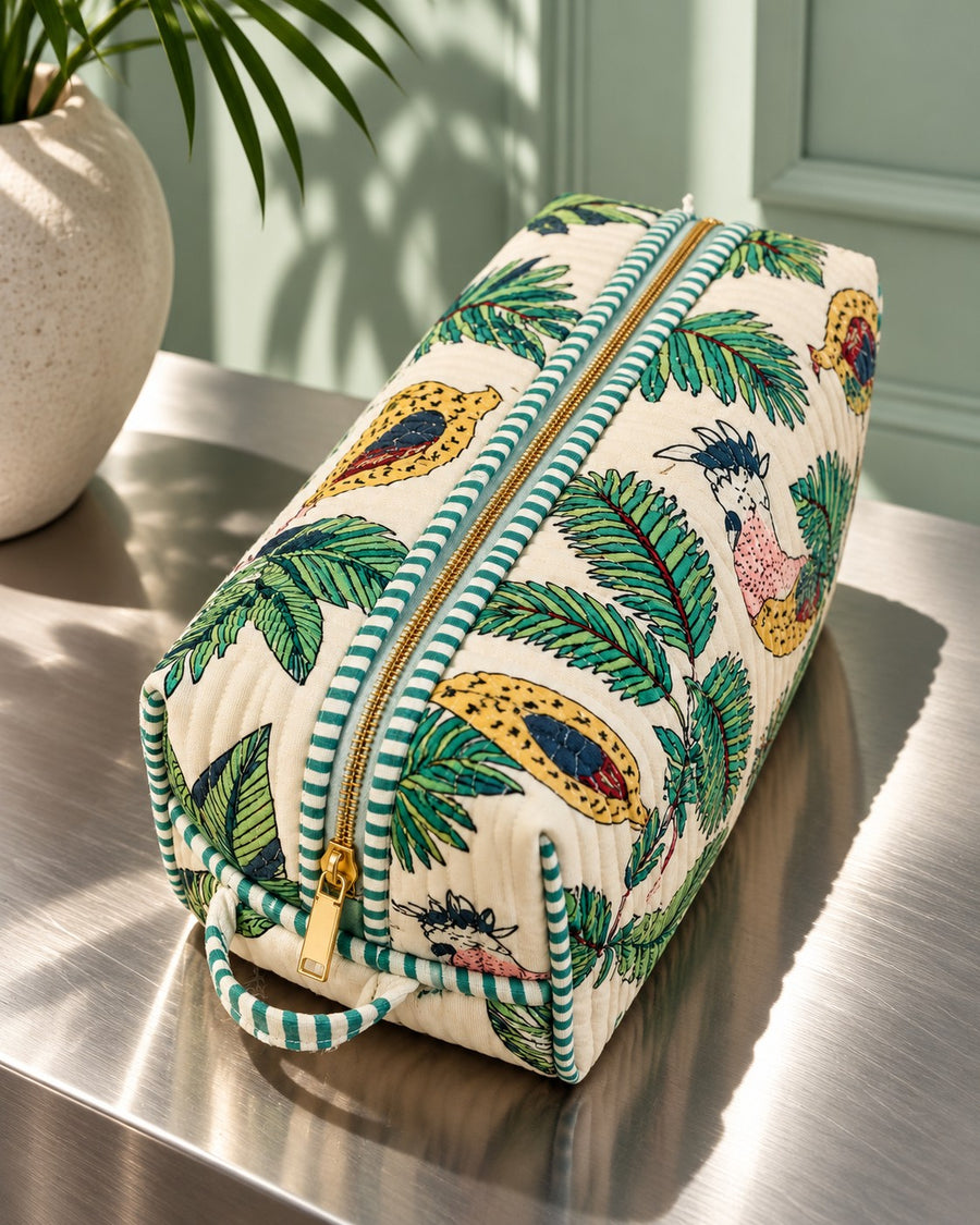 Vaan Quilted Hair Tool Bag on a steel table with a palm, pink zip detail (AI-generated styling image)