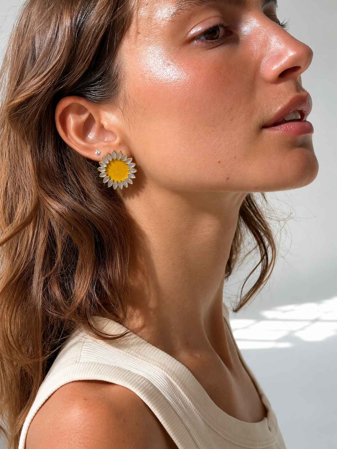 Yellow Floral Kundan Earrings in sunlight with an ivory ribbed top: kundan petals in gold-tone settings around a turmeric-yellow centre